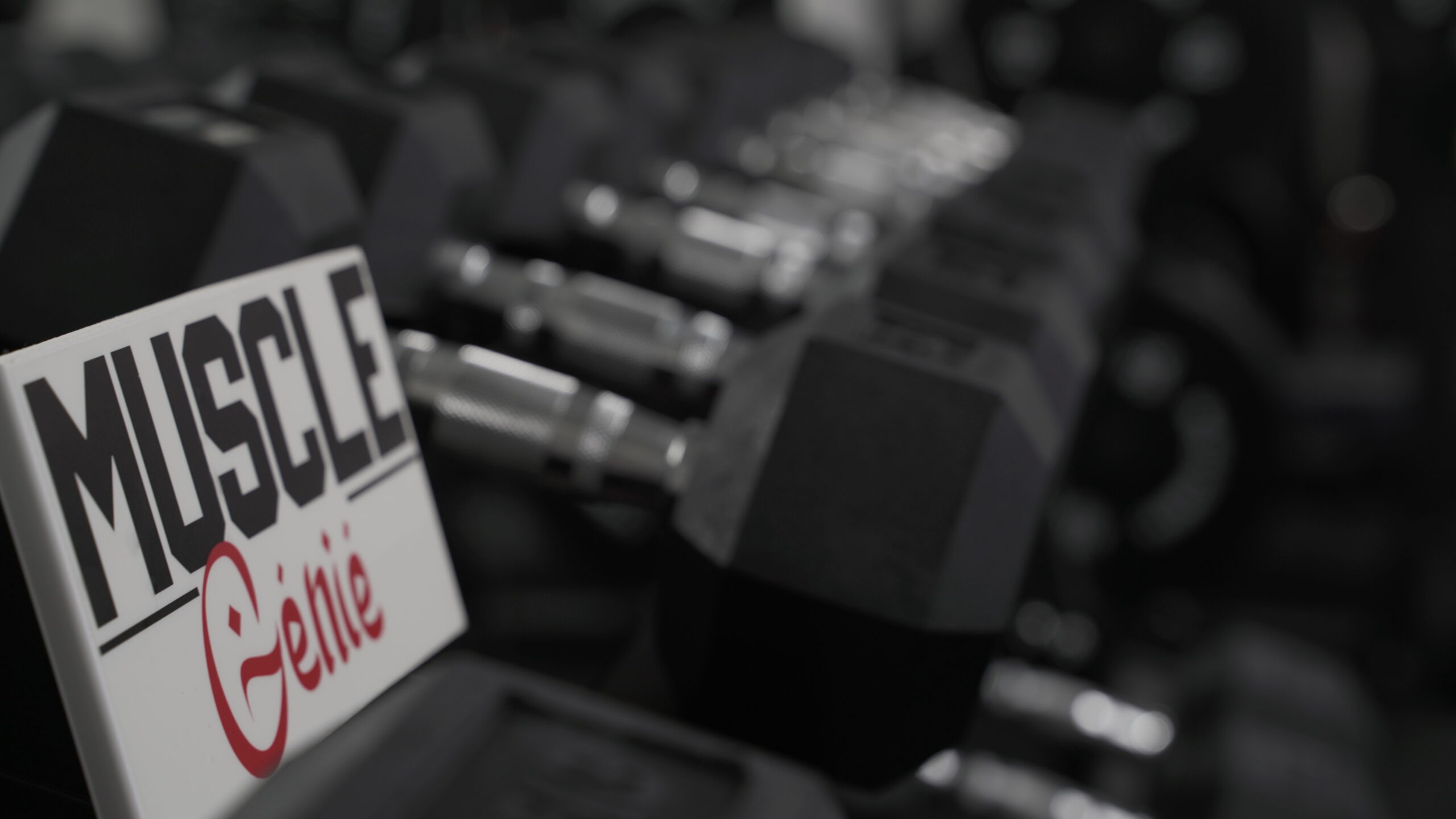 muscle genie plaque on dumbbell rack