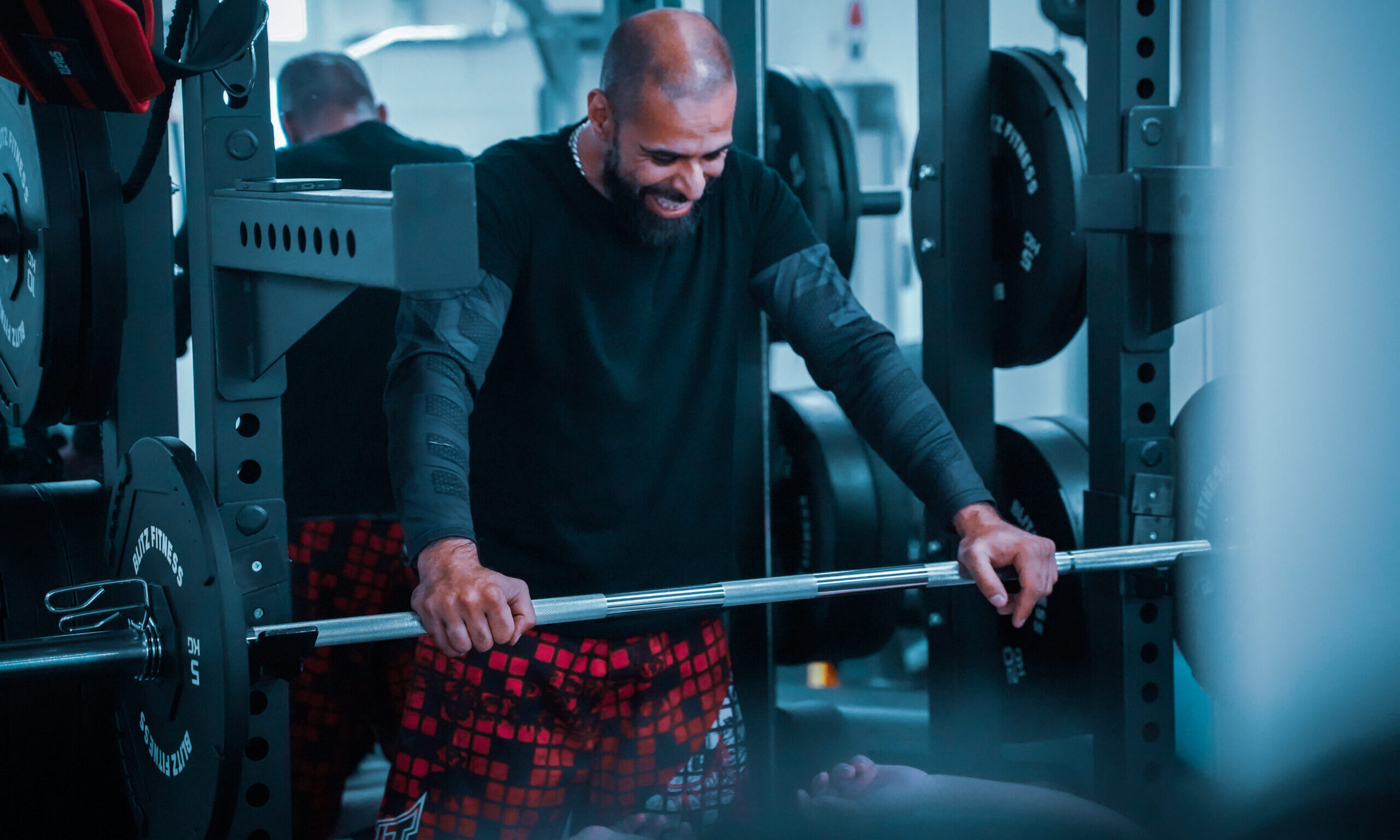 trainer smiling with client on bench