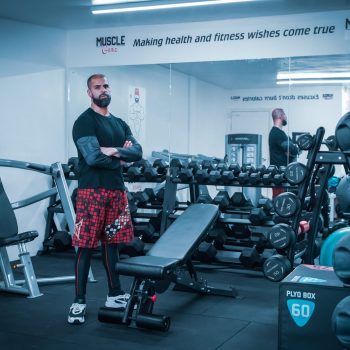 trainer with logo in gym