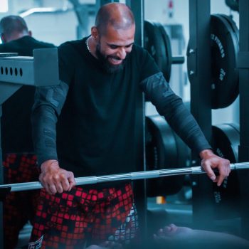 trainer smiling with client on bench