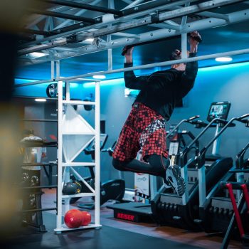 Personal Trainer doing pull up on frame